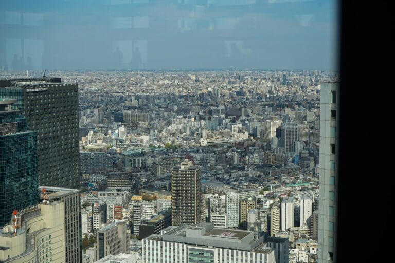 Interior view of a high-tech, minimalist micro-apartment "pod" in a dense urban metropolis, illustrating the new subscription-based living trend replacing homeownership.
